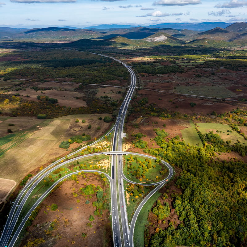 Airport activation & Internal Mobility Network droneshot of highway going throug Lika landscape