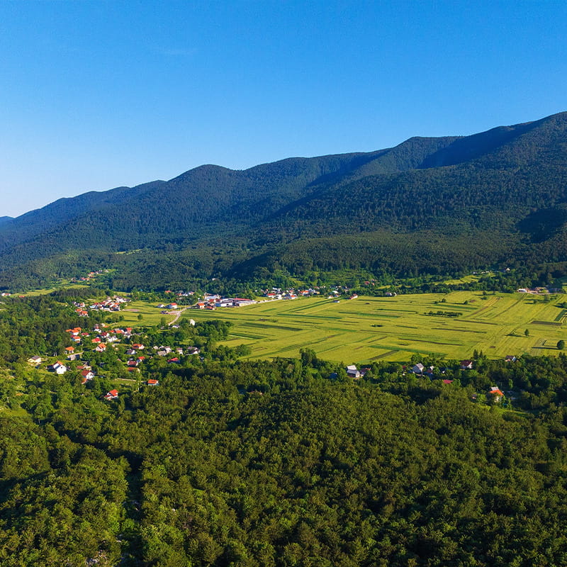 Living, Working & Belonging Krasno valley beneath Velebit mountain with green fields surrounded by forests