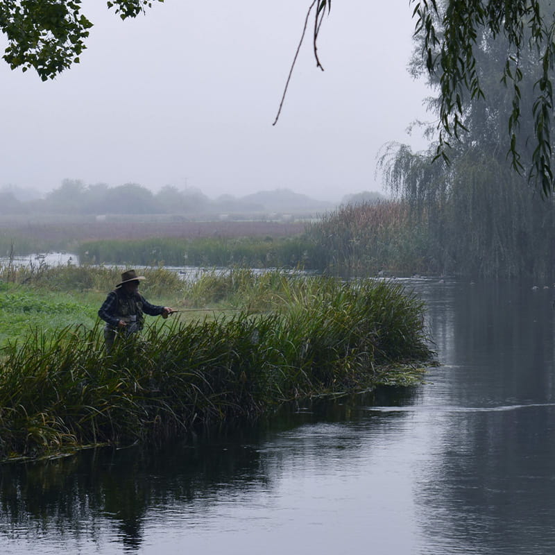 Location Autumn Rivers & Outdoor man fishing on banks of Gacka river during a foggy morning