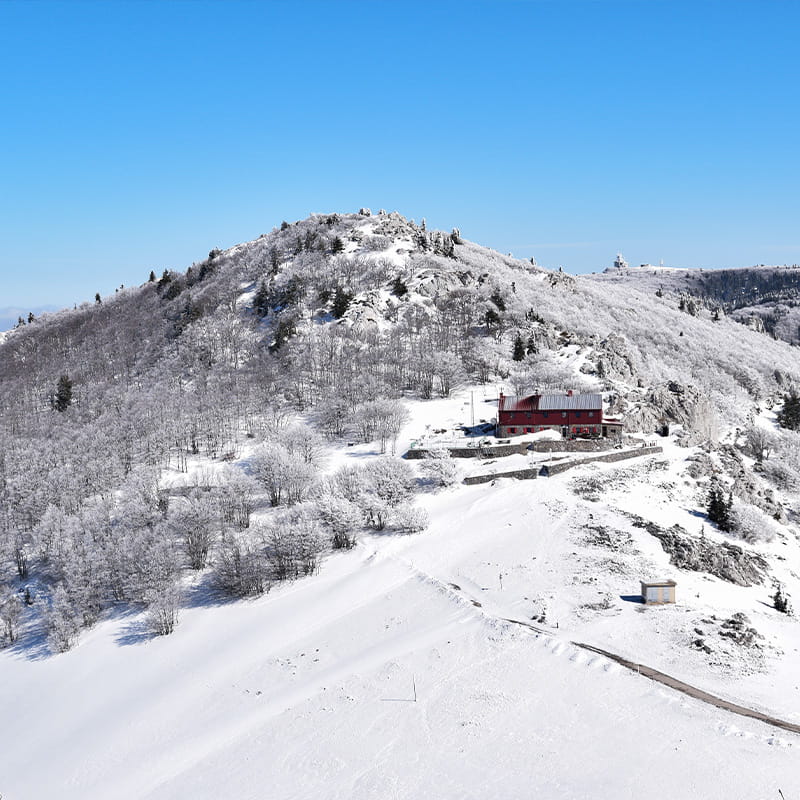 VPR Stillness, Privacy & Sensory Reset snowy mountain peak with a red mountain resort beneath on a clear winter day