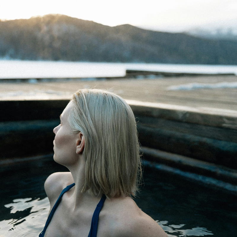 VPR Water & Thermal Rituals close up of a blonde woman in outdoor pool during a sunny winter day